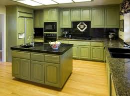 If you get an abundance of natural light in your kitchen, consider using rich shades like the olive green and pueblo wood brown in this kitchen. Cabinet Colors For Inexpensive Kitchen Makeovers