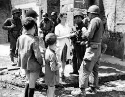 Us Troops With French Civilians Around The Water Fountain At Sainte Marie Du Mont American Soldiers D Day Wwii