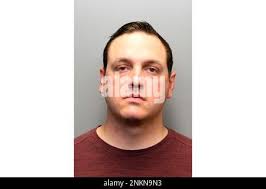 Fort Collins, Colo. Police officer Neal Hisam holds up a head board with  ropes attached that he had collected as evidence during the trial of William  Hunsaker at the Larimer County Justice