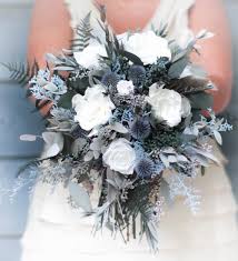 After all, no matter what shade of blue a bride chooses, this hue will jump out against the pale white or ivory of a wedding gown. Dusty Blue Steele Blue Slate Blue Bouquet Dried Flowers Etsy In 2020 Blue Wedding Flowers Winter Wedding Bouquet Winter Wedding Flowers