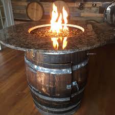 Handmade wine barrel fire pit that also functions as a table when not being used as a fire pit. 37 Sensational Fire Pits That Will Let You Soak Up Sunsets Barrel Fire Pit Gas Fire Pits Outdoor Wine Barrel Fire Pit