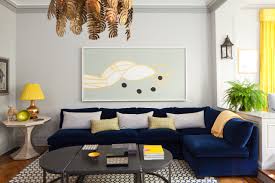 In this living room, the furniture is paired with decorative wallpaper in an abstract blue pattern. Decorating A Blue Couch Houzz