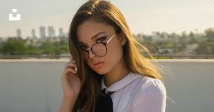 A girl in a school uniform is posing for a picture photo