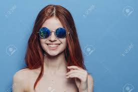 Perky Red-haired Woman In Blue Glasses Bare Shoulders Posing Stock Photo,  Picture And Royalty Free Image. Image 177673698.
