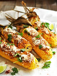 Mexican street corn, also known as elote, is grilled corn that is lathered in a mixture of mayonnaise, sour cream, cotija cheese, chili powder, garlic, and cilantro. Mexican Corn On The Cob Pinch And Swirl