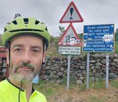 TED THORNHILL tries to cycle his 'dad belly' up Hardknott Pass in the Lake  District