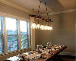 The Eagles Nest Rustic Barn Wood Chandelier Etsy In 2021 Rustic Chandelier Lighting Dining Room Light Fixtures Dining Room Lighting Chandeliers
