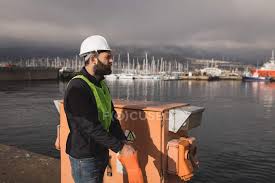 Maybe you would like to learn more about one of these? Dock Worker Wearing Gloves In Shipyard On A Sunny Day Infrastructure Male Stock Photo 209056992
