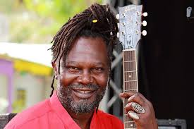 Does Dragons' Den star Levi Roots play Billy in Death in Paradise? Is  Dwayne's dad Nelson Myers from Desmond's