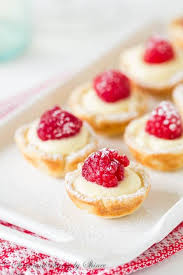 These Little Flaky Tart Shells Filled With Silky Smooth Lemon Cream Filling And Topped With Juicy Fresh Raspberries Are Co Desserts Tart Recipes Lemon Tartlets