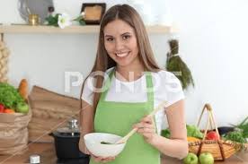 Photograph Young Happy Woman Cooking In The Kitchen Healthy Meal Lifestyle And Culinary 101169847 Cooking Kitchen Healthy Recipes Healthy
