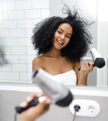 Turn the blow dryer on and slowly move it down the strip of hair along with the brush. How To Blow Drying Curly Hair