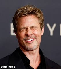Brad Pitt plays up to the cameras during Babylon photocall in Paris