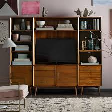 Each door reveals two adjustable shelves to keep media, linens and dinnerware neatly organized and safely tucked away. Mid Century Media 6 Piece Set Acorn Entertainment Center