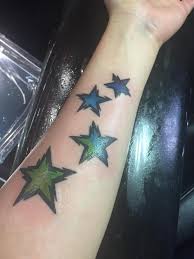 The most popular simple arm tattoo design is probably the simple lines and armbands. Colored Star Tattoos On Left Forearm