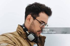 Candid Shot Of Stylish Guy Listening To Contemporary Music Using His  Headphones Walking In The Misty Park Of The City Street Fashion Style  People Lifestyle And Technology Concept Copy Space Stock Photo -