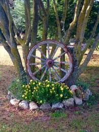 Image Result For Wagon Wheels In Yard Ideas Wagon Wheel Decor Wagon Wheel Garden Wagon Wheel