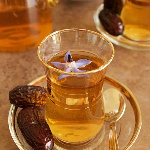 Cup of loomi tea with dried lime pieces showing health benefits