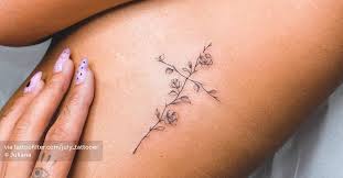 Although most flowers would make great additions to your tattoo garden, some are more popular than others. Fine Line Flower Cross Tattoo On The Rib