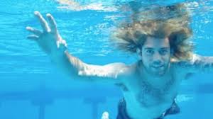 The cover of nirvana's 1991 album nevermind. cobain commissioned the shoot after he had seen a documentary on babies being born underwater and thought the image would make a cool cover, fisher. Nirvana S Nevermind Baby Recreates Album Cover 25 Years On Louder
