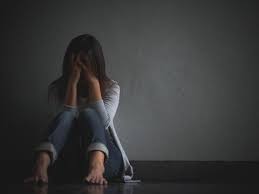 La donna triste abbraccia il suo ginocchio e piange, seduto da solo in una stanza vuota | Foto Premium