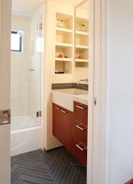 The bathtub of volcanic limestone and resin is by victoria + albert, and a ladder shelf keeps towels at a hand's reach. Chevron Bathroom Tile Floors A Storied Style