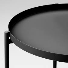 Here is a round shape coffee table that costs less also. Gladom Tray Table Black 17 1 2x20 5 8 Ikea