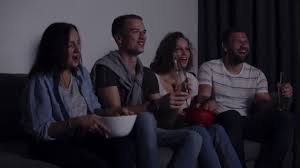 Find a movie or show to watch. Friends Of Four Sit On Couch Watch Funny Film On Tv Caucasian Young Group Sit On The Couch Drinks And Snacks Movie Night Video By C Patramansky Stock Footage 222072842