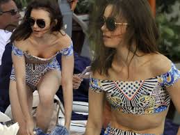 Lily Collins tops up her tan on the beach in a patterned swimsuit following  Netflix film premiere in Italy - Mirror Online