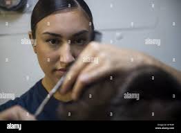 PACIFIC OCEAN (April 6, 2017) Ship's Serviceman Seaman Roxanne Salinas,  from Sacramento, Calif., cuts a Sailor's hair aboard the Arleigh  Burke-class guided-missile destroyer USS Howard (DDG 83) while underway  conducting a composite