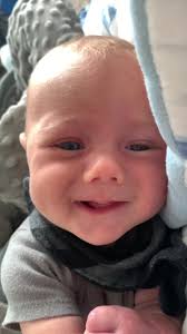 Beautiful Baby Boy with Blue Eyes Smiling Brightly