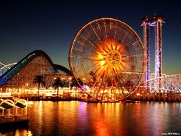 Cars parked on sidewalk beside buildings during daytime. Wallpaper Ferris Wheel Amusement Park Tourist Attraction Download Top Free Backgrounds
