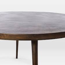 Charming rustic coffee table features a distressed wood top set off by the antique bronze finish of its metal frame. Cast Coffee Table Antique Bronze