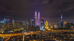 One of city's busiest intersections on friday night (bukit bintang district). Time Lapse Night View Of Kuala Lumpur City Overlooking The National Landmarks In Pink During The Breast Cancer Awareness Campaign With Pan To Right Effect 4k