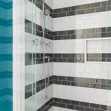 Create a glamorous bathroom base with shiny black marble tiles as your base. Black And White Striped Subway Shower Wall Tiles Design Ideas