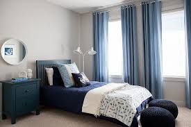 The dark blue used on the accent walls of this cottage living room is the perfect partner to the bright white paint used on the wainscot and door and window frames. Gray And Blue Bedroom Ideas 15 Bright And Trendy Designs