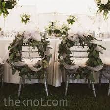 The Newlyweds Chairs Were Decorated With Leafy Wreaths Wrapped In Tulle Ribbon Wedding Wreaths Bride Groom Chairs Wedding Chairs