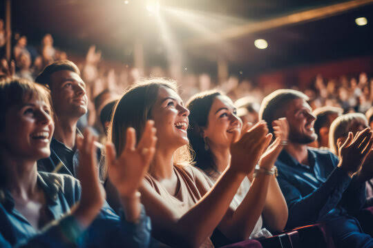 Audience in theater applauding, clapping hands, cheering, sitting together, and having fun in backlight. Visitors in theater, cinema, show. Happy. Stock Photo | Adobe Stock