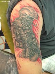 Grey ink army skull gun and boots tattoo on men shoulder. Grey Ink Army Skull Gun And Boots Tattoo On Men Shoulder Segerios Com