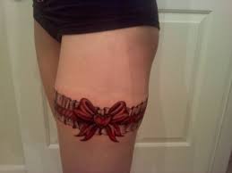 People are opting for a rainbow choice instead of the classic. Red Ink Bow Garter Tattoo On Thigh