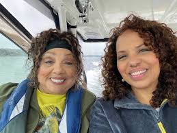 On her family's boat off the rugged coast of Maine, are my daughter and me.  People say we look alike. Really?