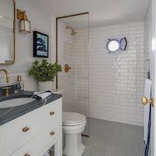 A shower space done with marble tiles and marble penny tiles plus copper fixtures for a vintage touch. Navy Penny Tile Floor Design Ideas