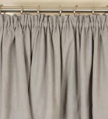 Close up of red and white pattern draperies with striped lining. Curtain Headings Explained Just Fabrics