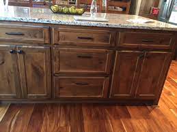 Apply the stain of even strokes with a brush or sponge to staining knotty alder cabinets. Valley Custom Cabinets Rustic Knotty Alder Cabinets Stillwater Mn