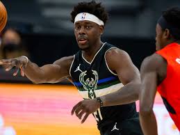 New orleans pelicans guard jrue holiday, left, drives to the rim for a basket past denver nuggets forward paul millsap and center nikola jokic during the first half of an nba basketball game. Jrue Holiday Makes Milwaukee Bucks Look Invincible Sports Illustrated