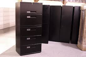 This lateral file cabinet features a simple, durable design made with contrasting materials that reflect a modern industrial aesthetic. Used Global File Cabinets 5 Drawer Lateral File