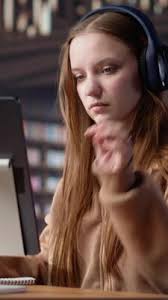 Vertical Young female adult listening to therapy music and working