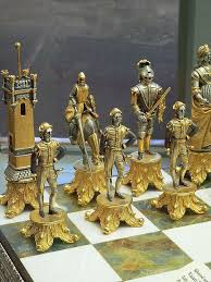 This Silvered And Gilded Bronze Vasari Figural Chess Set Rests On A Board Of Silver Framed Polished Italian Onyx 1 2 Chess Set Chess Board Chess