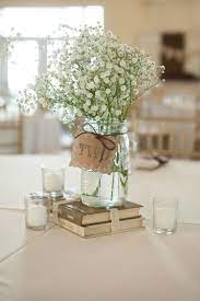 Rustic Wedding Centerpiece With White Gypsophila And Tea Lights Wedding Table Centerpieces Wedding Centerpieces Diy Wedding Decorations Centerpieces