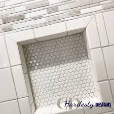White Penny Tile Shower Niche With A Natural Stone Mosaic Accent From A Bathroom Remodel Project Shower Niche Tile Shower Niche Bathroom Design Inspiration